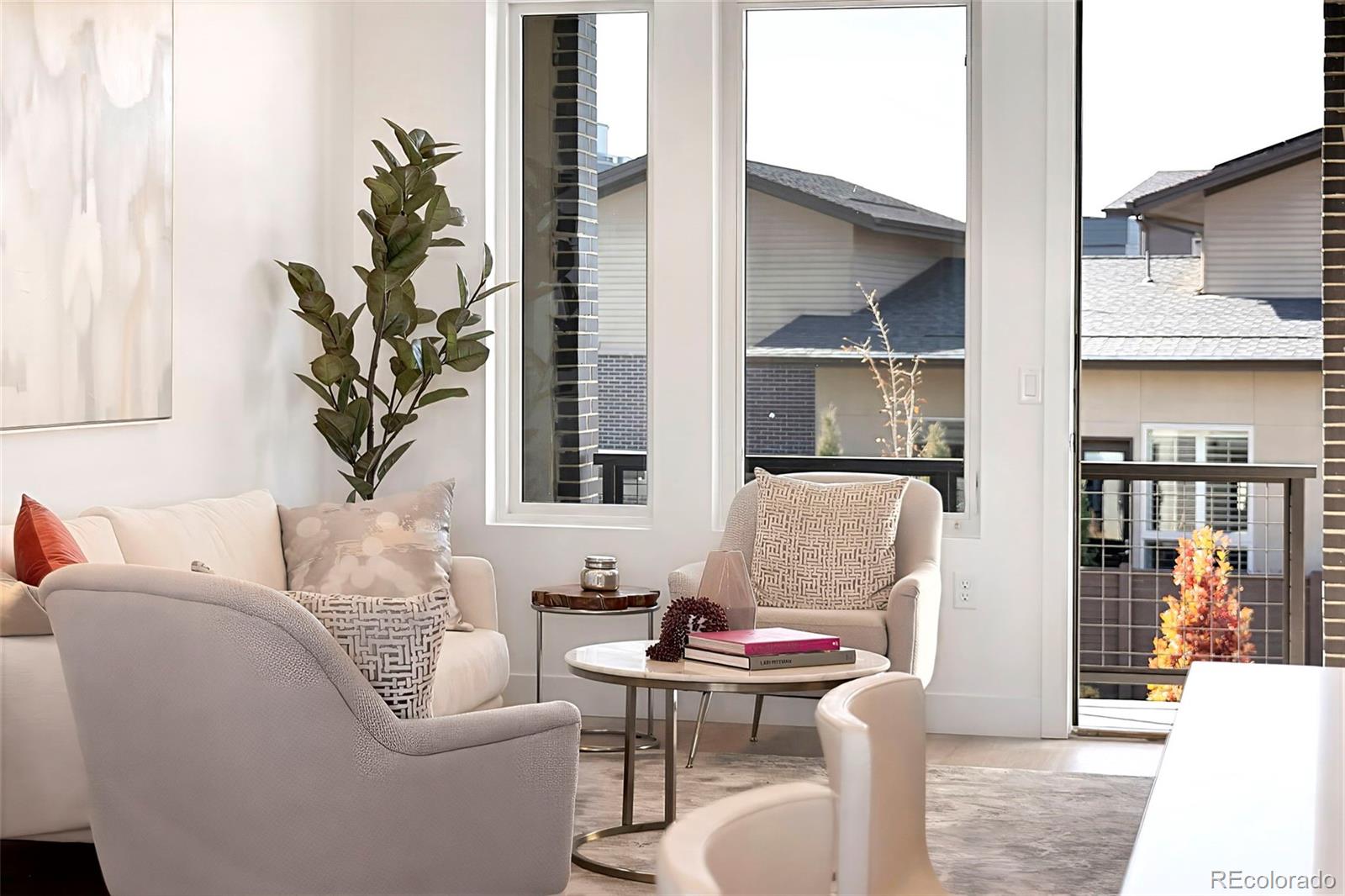 22 Oneida Court Denver, CO 80230 - Photo 6 of 44 a living room with furniture a lamp and a potted plant
