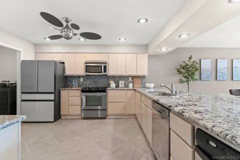 a view of open kitchen with living room and furniture