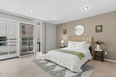 a bedroom with a bed and painting on the wall