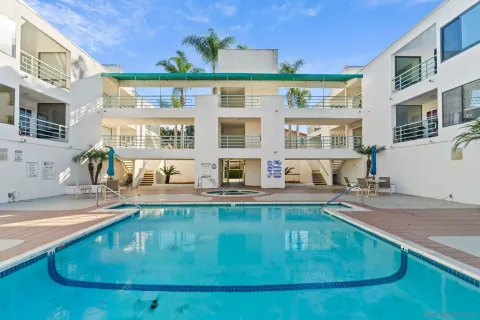 a view of a house with pool and sitting area