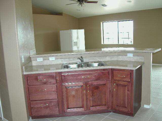 1053 Paseo Guebabi Rio Rico, AZ 85648 - Photo 3 of 5 a bathroom with a granite countertop sink and a mirror