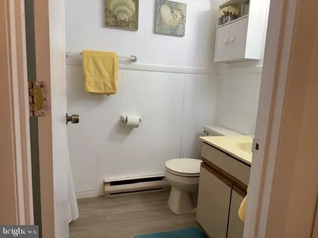 a white toilet sitting next to a bathroom sink