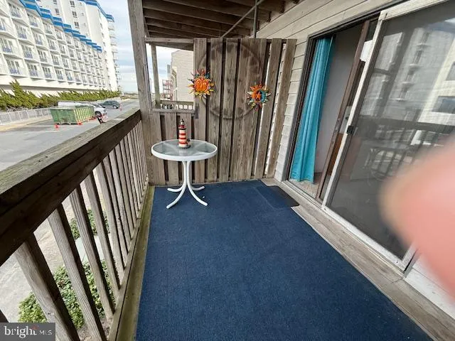 a view of a hallway with furniture and a window