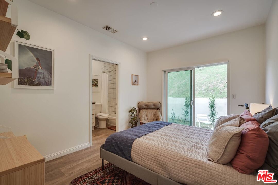 4535 Dudley Drive Los Angeles, CA 90032 - Photo 12 of 24 a bedroom with a bed and a large window