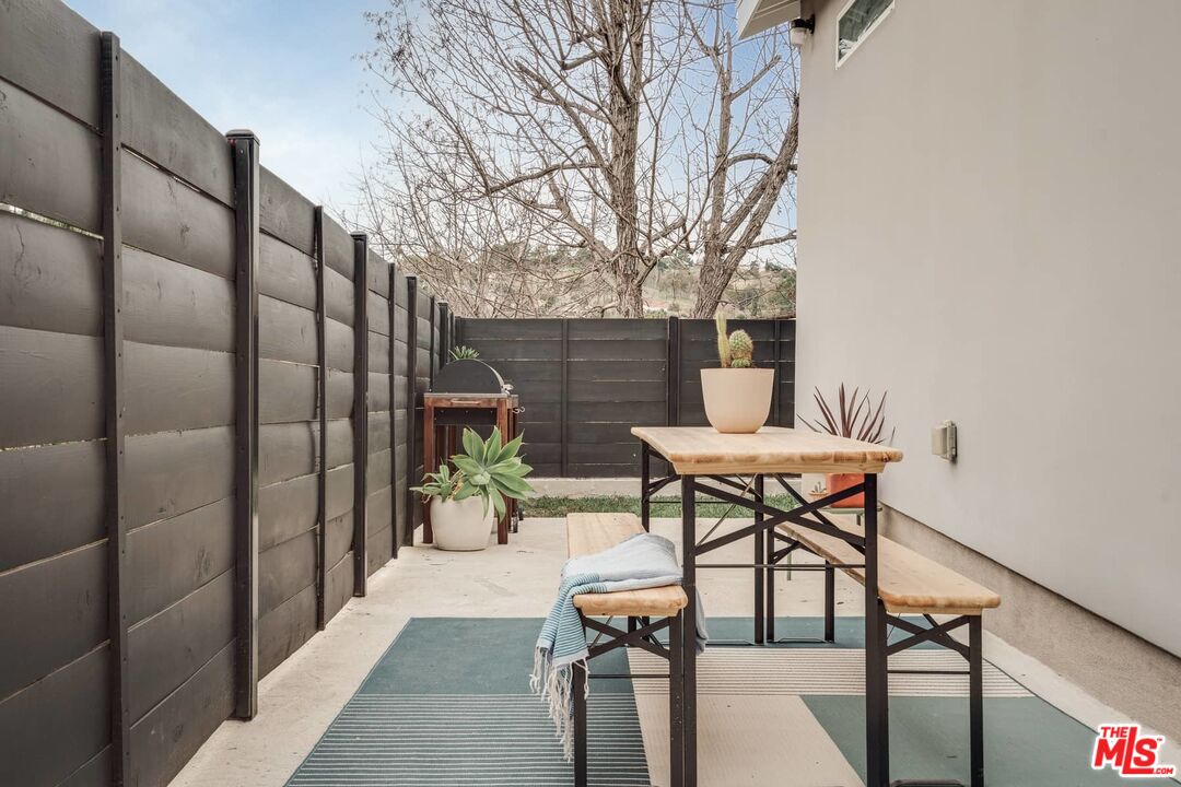 4535 Dudley Drive Los Angeles, CA 90032 - Photo 21 of 24 a patio with table and chairs and potted plants