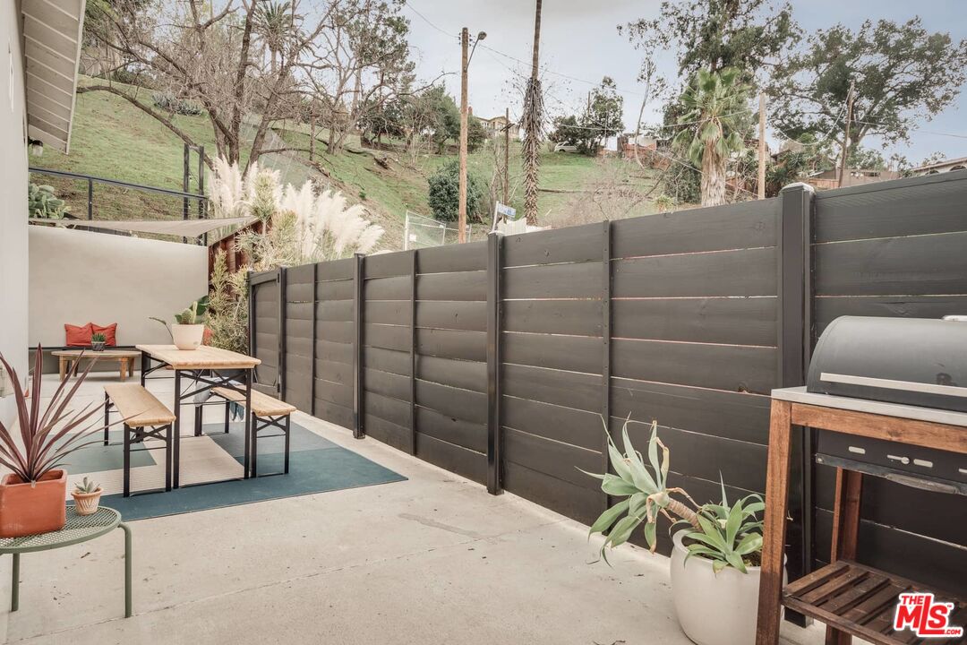 4535 Dudley Drive Los Angeles, CA 90032 - Photo 22 of 24 a view of a patio with a table and chairs and potted plants