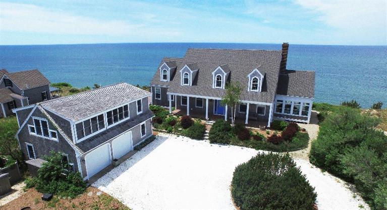 an aerial view of a house with a yard
