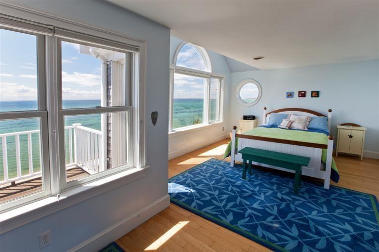 64 Corn Hill Road Truro, MA 02666 - Photo 13 of 30 a living room with a rug table and a large window