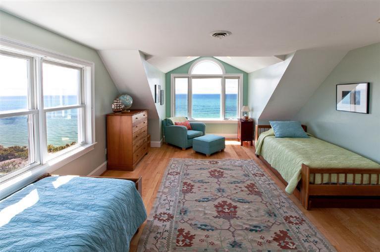 64 Corn Hill Road Truro, MA 02666 - Photo 15 of 30 a bedroom with furniture and a large window