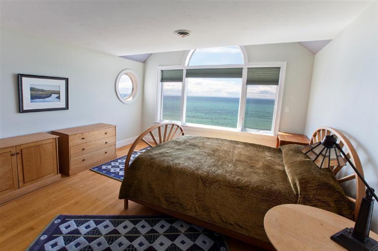 64 Corn Hill Road Truro, MA 02666 - Photo 17 of 30 a bedroom with a bed and window