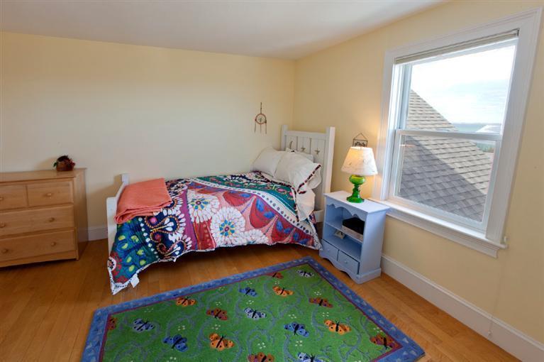 64 Corn Hill Road Truro, MA 02666 - Photo 18 of 30 a bedroom with a bed and a dresser in it