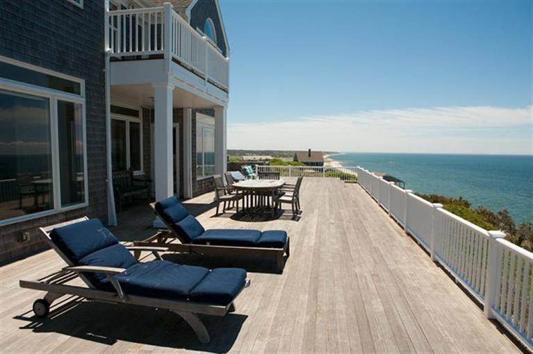 64 Corn Hill Road Truro, MA 02666 - Photo 21 of 30 a view of a balcony with chairs and wooden floor
