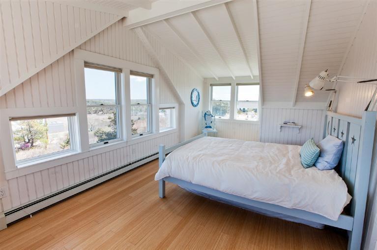 64 Corn Hill Road Truro, MA 02666 - Photo 27 of 30 a bedroom with a large bed and a large window