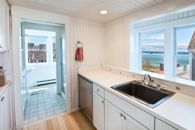 64 Corn Hill Road Truro, MA 02666 - Photo 28 of 30 a view of a sink and dishwasher with wooden floor