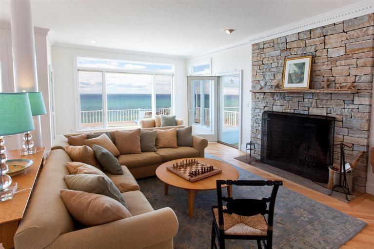64 Corn Hill Road Truro, MA 02666 - Photo 7 of 30 a living room with furniture a large window and a fireplace