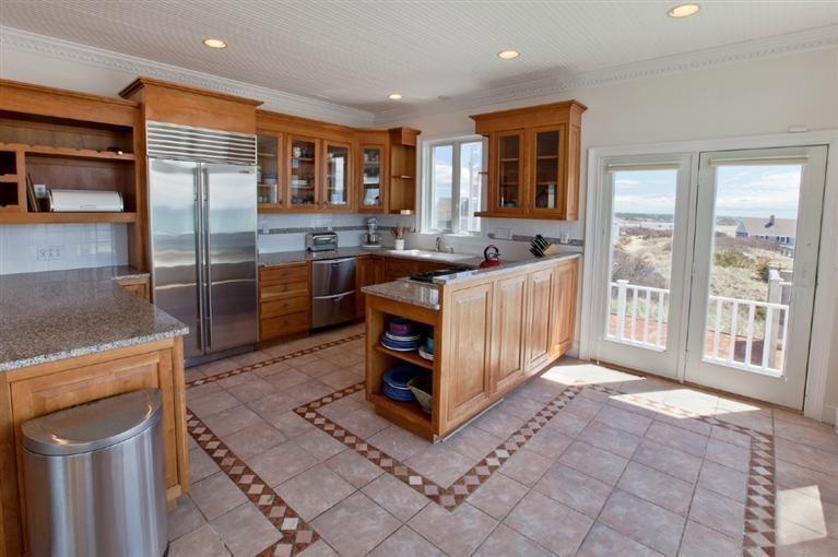 64 Corn Hill Road Truro, MA 02666 - Photo 10 of 30 a kitchen with stainless steel appliances granite countertop a stove and a refrigerator