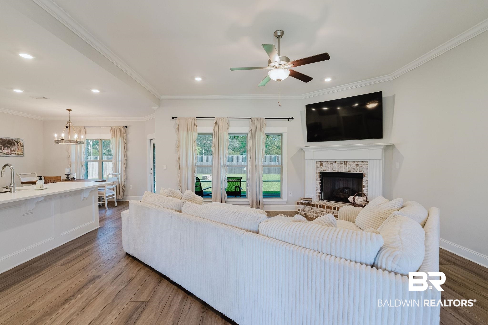 7872 Calverton Street Foley, AL 36535 - Photo 30 of 76 Open-concept living space featuring wood-finish flooring and a central ceiling fan