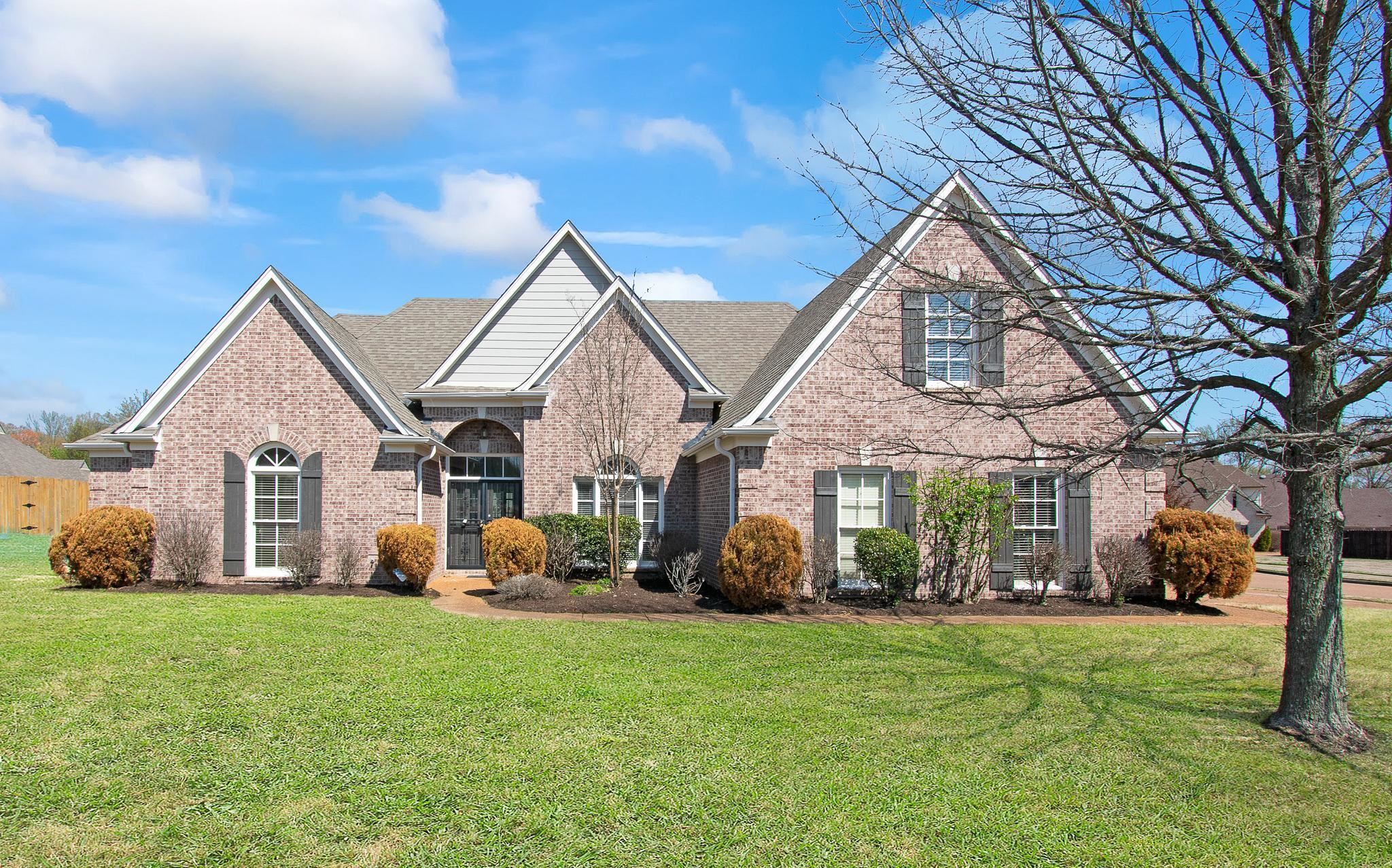 6024 Maher Trail Bartlett, TN 38135 - Photo 1 of 25 a front view of a house with garden