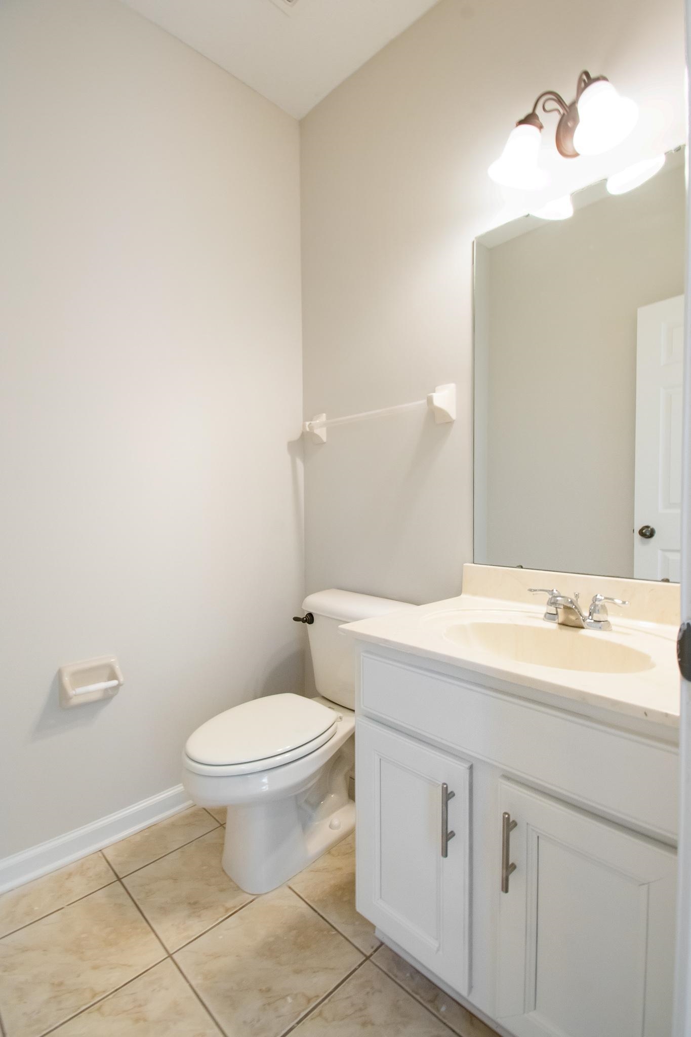 6024 Maher Trail Bartlett, TN 38135 - Photo 13 of 25 a bathroom with a granite countertop sink a toilet and a mirror