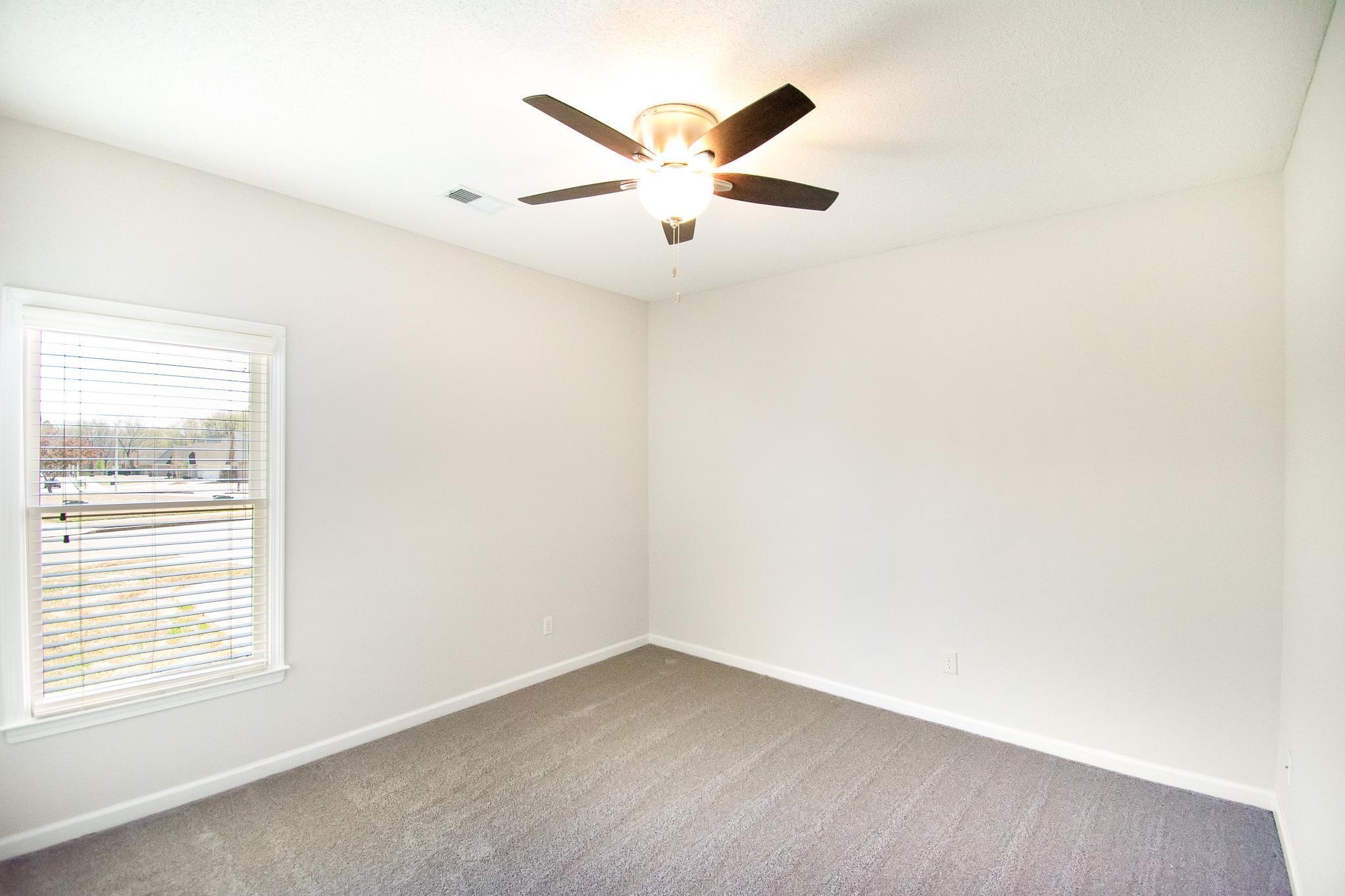 6024 Maher Trail Bartlett, TN 38135 - Photo 15 of 25 an empty room with window and ceiling fan