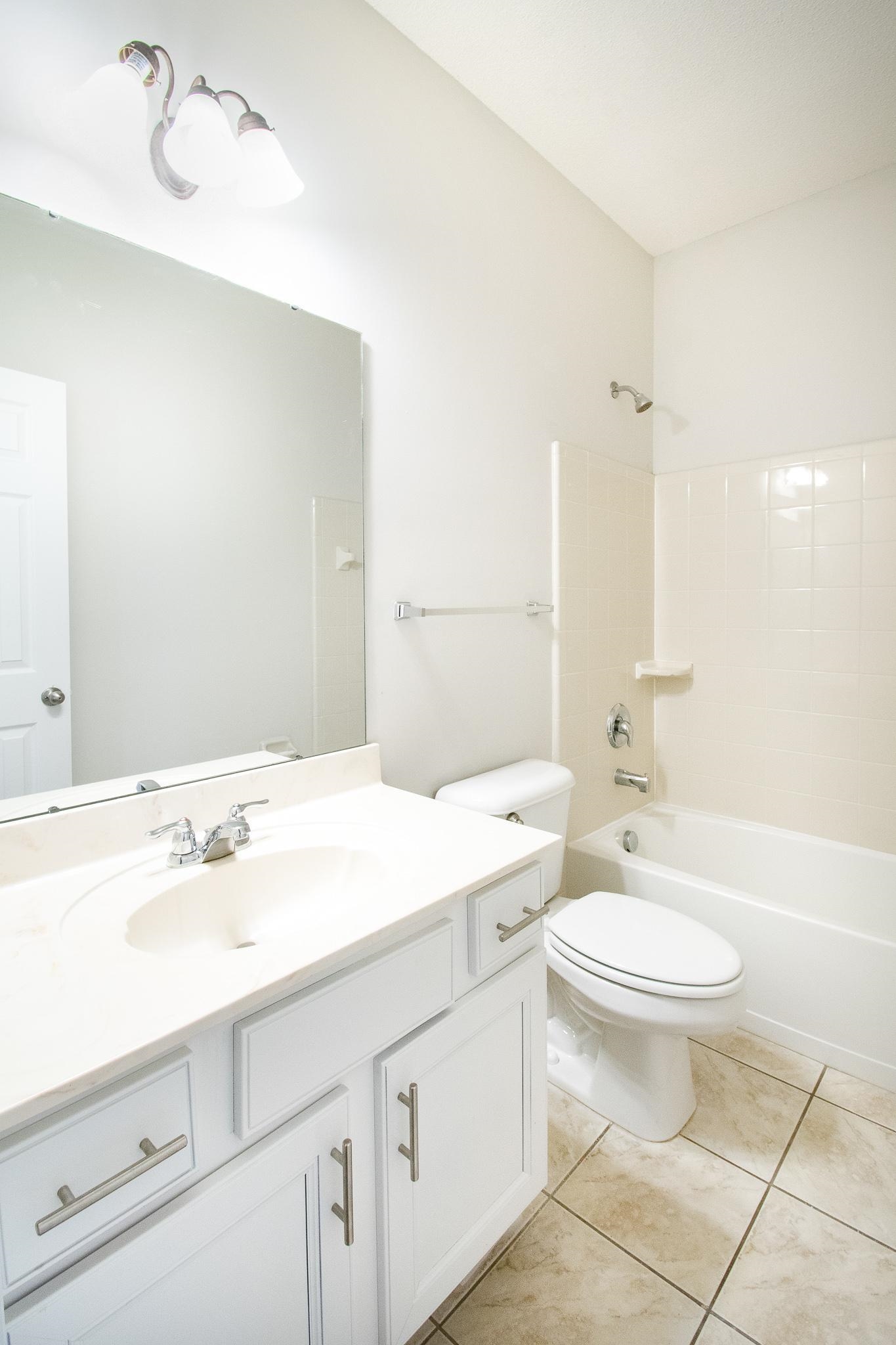 6024 Maher Trail Bartlett, TN 38135 - Photo 18 of 25 a bathroom with a sink a toilet a mirror and vanity