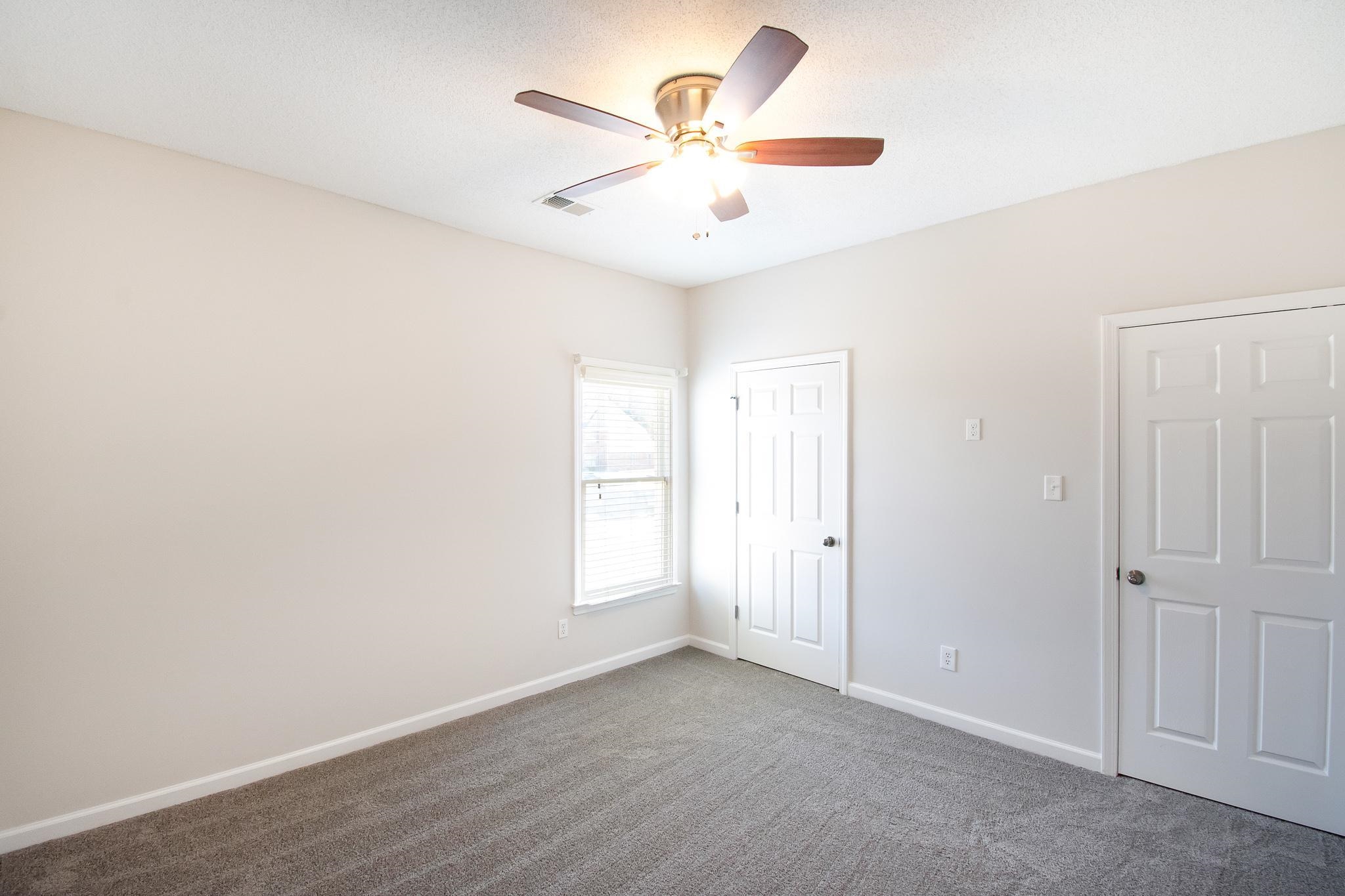 6024 Maher Trail Bartlett, TN 38135 - Photo 19 of 25 an empty room with a ceiling fan and a window