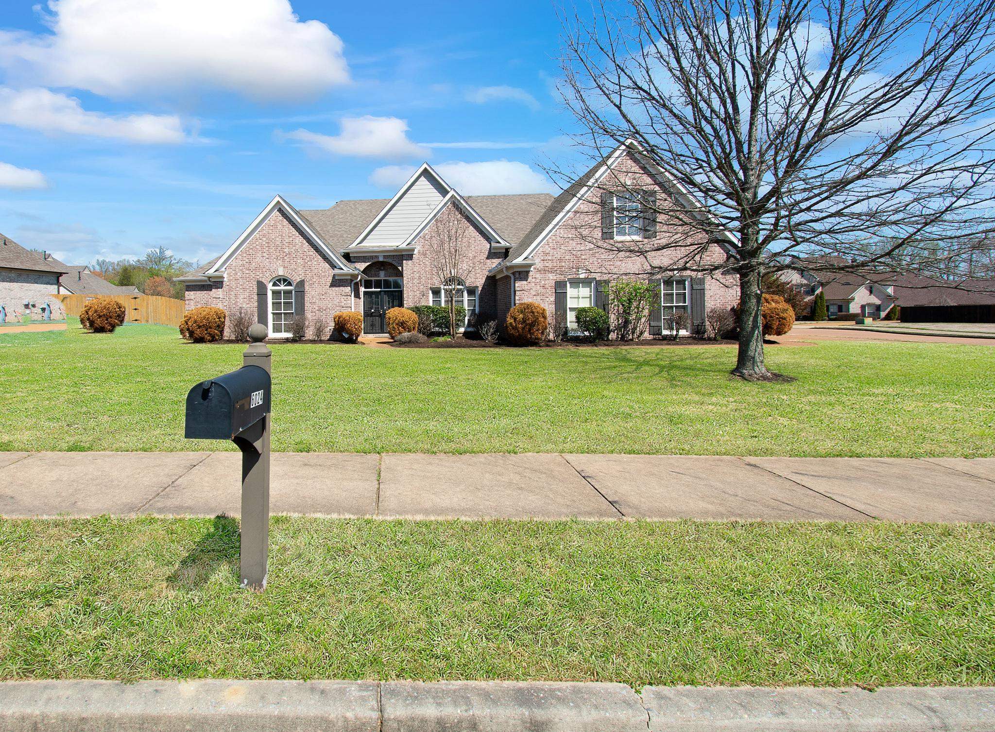 6024 Maher Trail Bartlett, TN 38135 - Photo 2 of 25 a front view of a house with garden