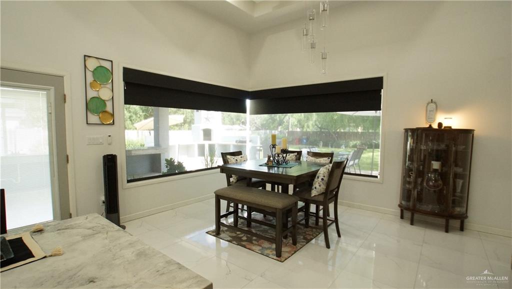 414 Ric Mar Street Edinburg, TX 78541 - Photo 16 of 36 Spacious interior featuring a vaulted ceiling, white tile flooring, and large windows with integrated blinds
