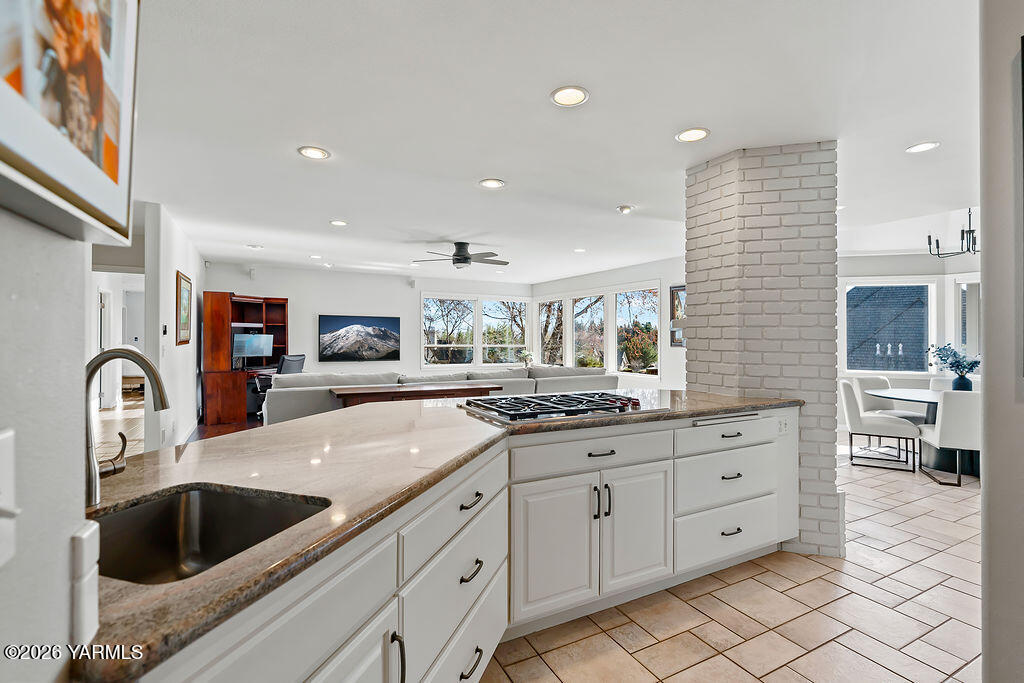 6810 Ravens Gate Way Yakima, WA 98908 - Photo 6 of 49 a kitchen with cabinets a sink and a stove