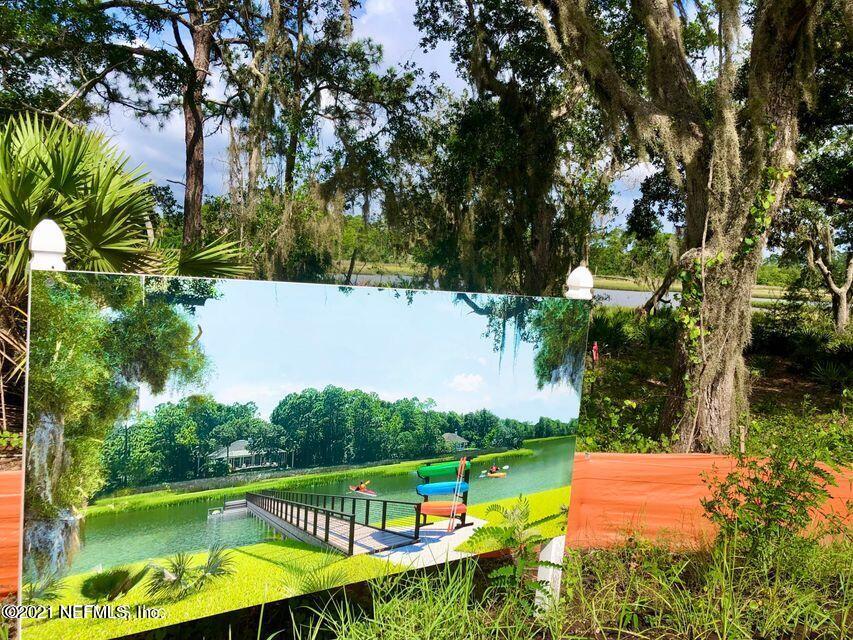 137 Canopy Hall Dr Street St. Augustine, FL 32095 - Photo 5 of 7 an aerial view of a house with a garden and swimming pool