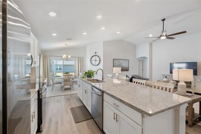 a kitchen with sink stove and refrigerator