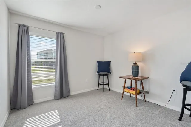 a view of a livingroom with furniture and a window
