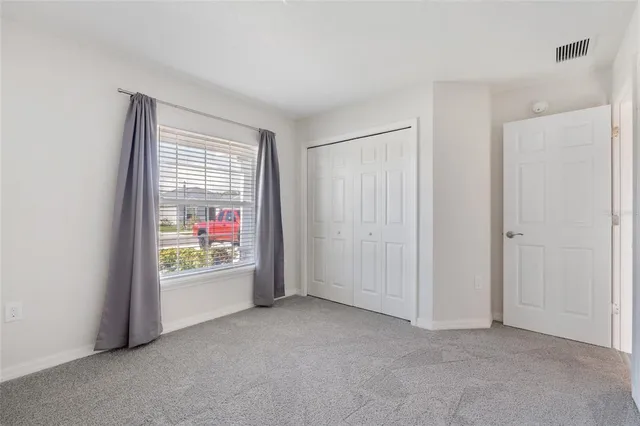 a view of an empty room and a window