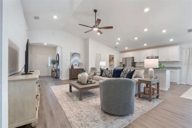 a living room with lots of furniture and a chandelier