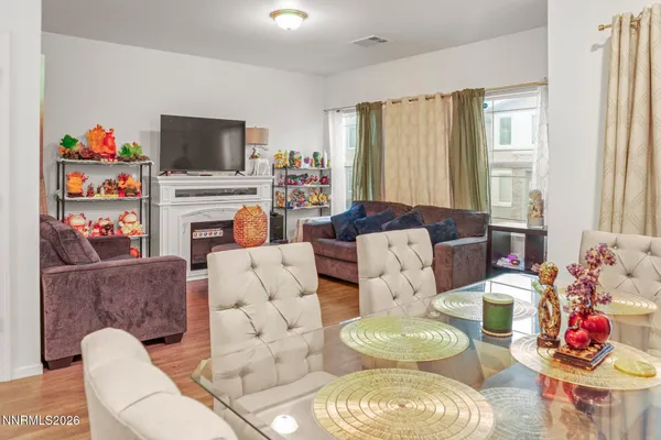 a living room with furniture flat screen tv and a large window
