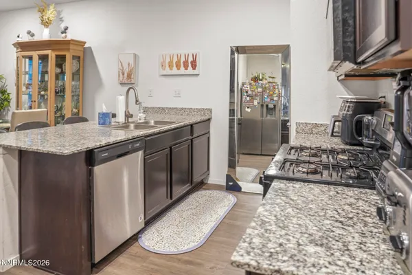 a kitchen with sink stove and refrigerator