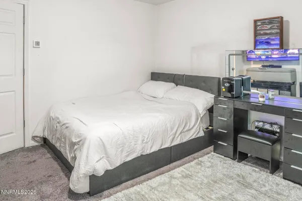 a bedroom with a bed and a dresser