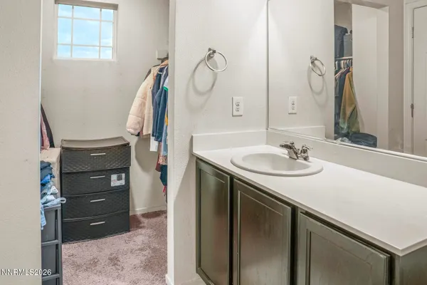 a bathroom with a sink vanity and a mirror