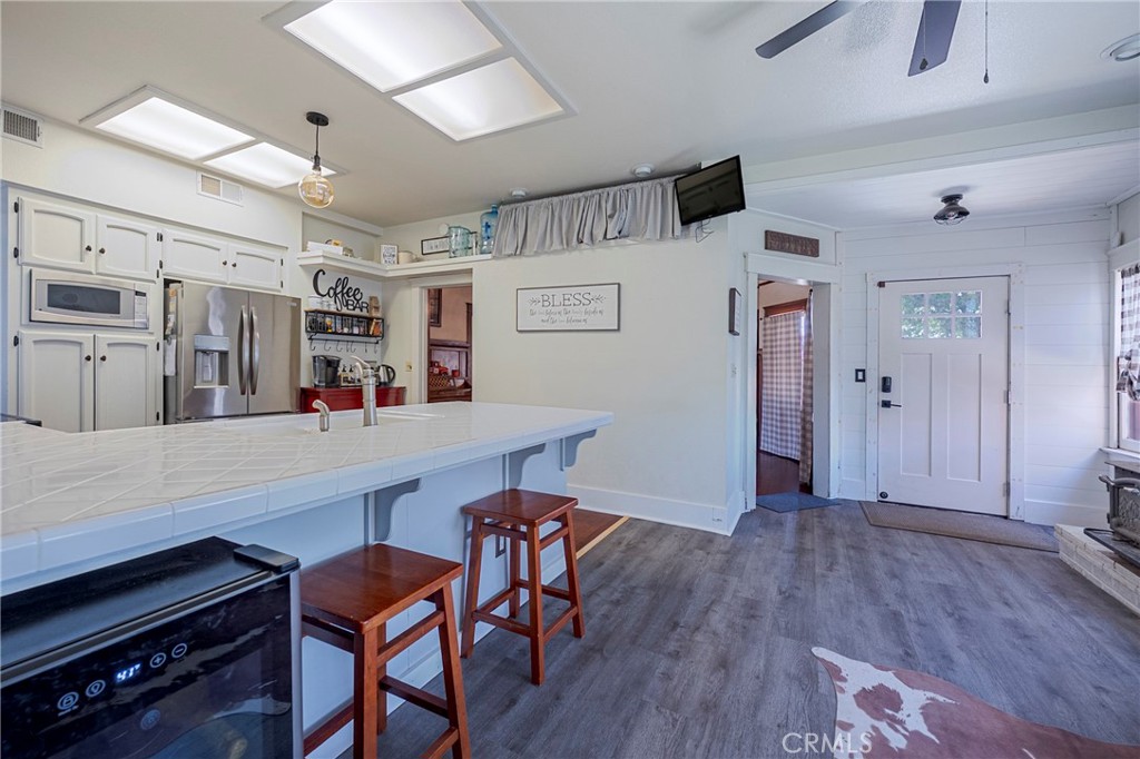 14625 Le Grand Road Le Grand, CA 95333 - Photo 33 of 60 a room with stainless steel appliances wooden floor and chairs