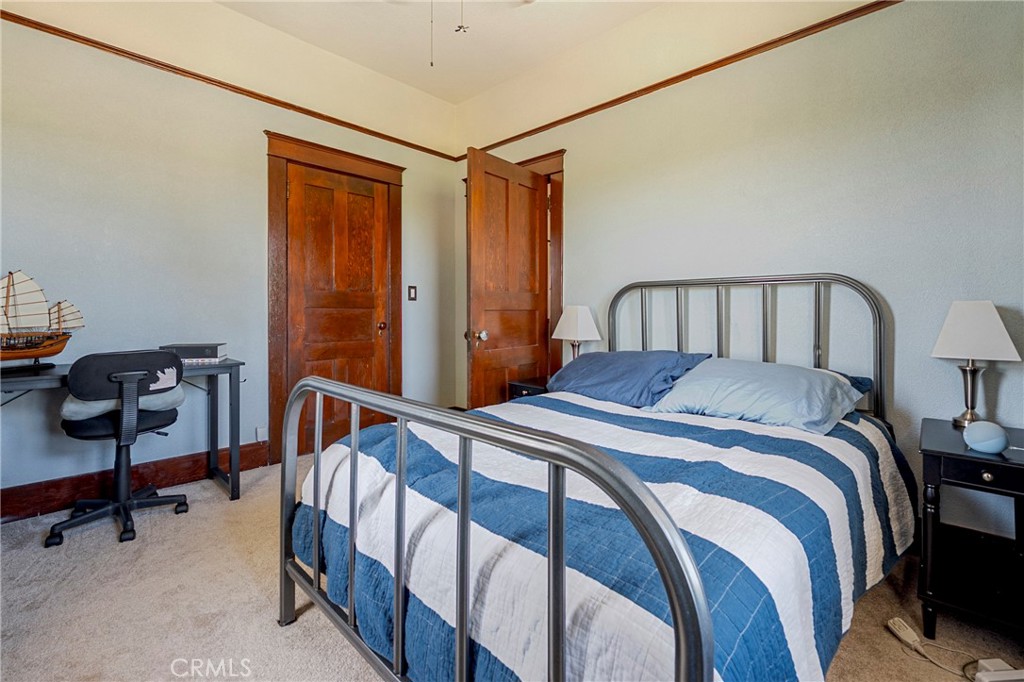 14625 Le Grand Road Le Grand, CA 95333 - Photo 45 of 60 a bedroom with a bed a desk and chair with the wooden floor
