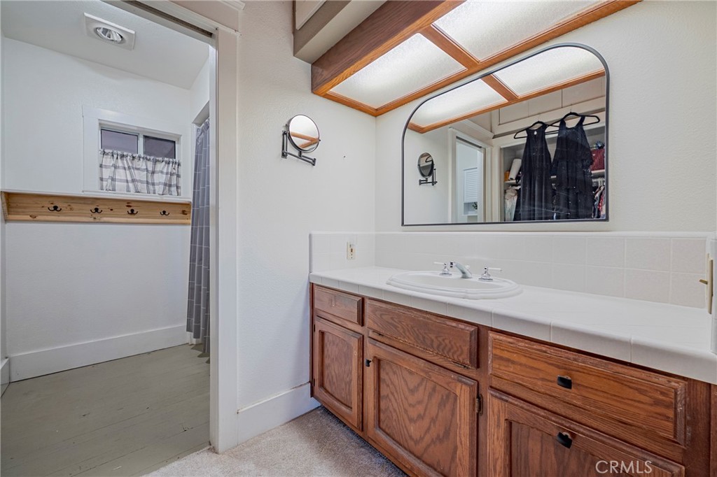 14625 Le Grand Road Le Grand, CA 95333 - Photo 54 of 60 a bathroom with a double vanity sink and mirror