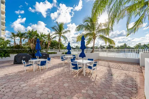 a view of a patio with swimming pool and sitting area