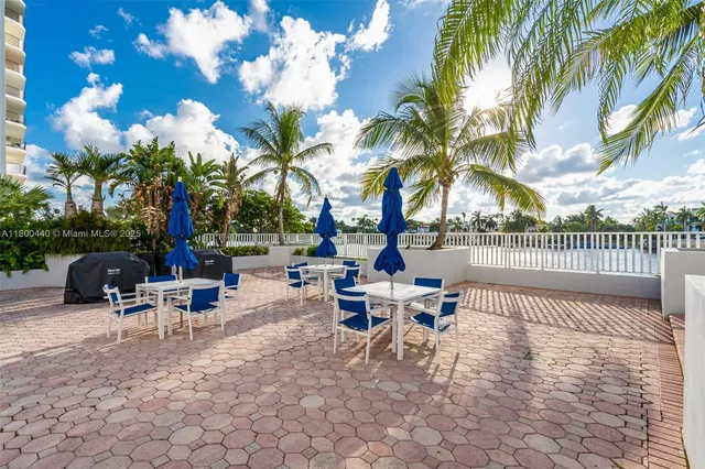 a view of a patio with swimming pool and sitting area