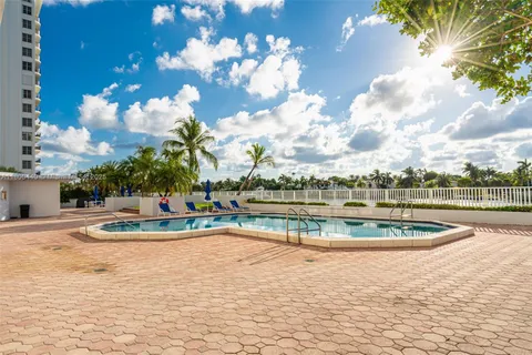 a view of a swimming pool with a table and chairs