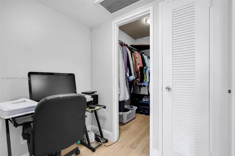 a view of a workspace with furniture and closet