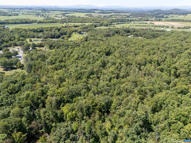 an aerial view of a houses with a yard