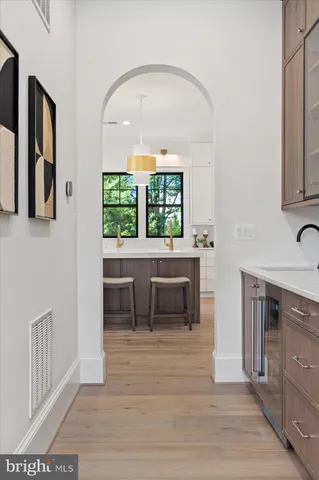 a large kitchen with kitchen island a sink stainless steel appliances and cabinets