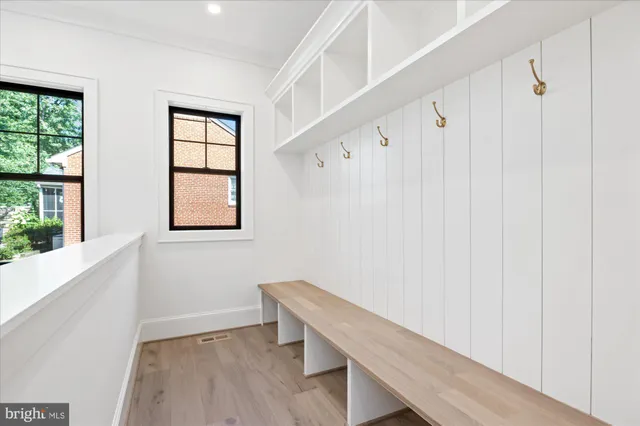 a view of a hallway with wooden floor and entryway