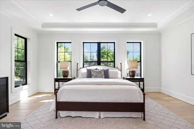 a bedroom with a bed a couch and window