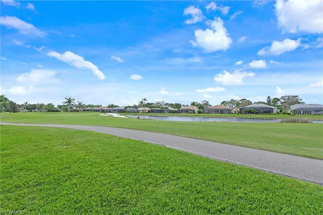 a view of field with grass and trees in the background